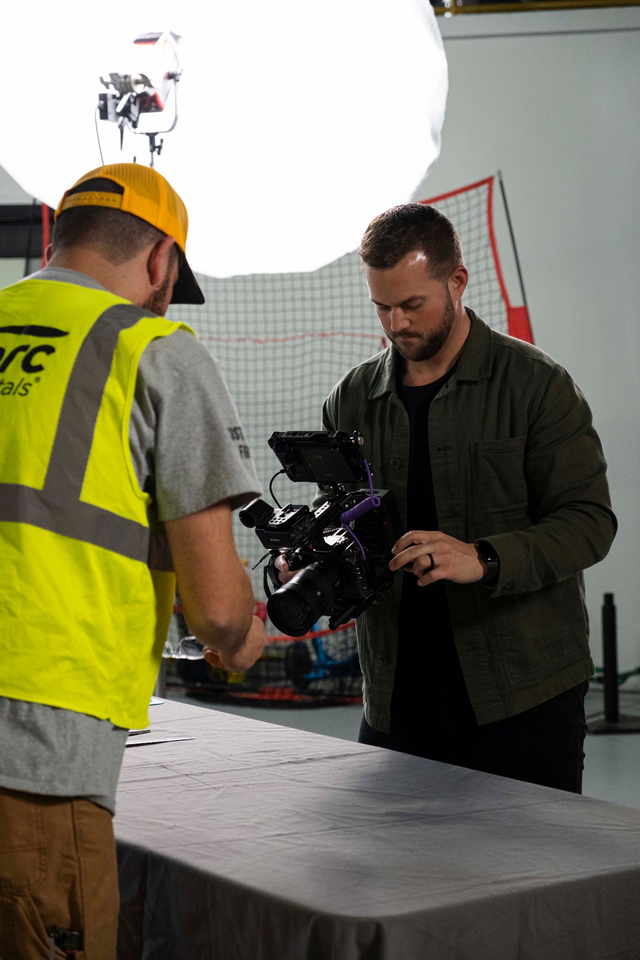 Director discussing the shot with talent under a lit softbox