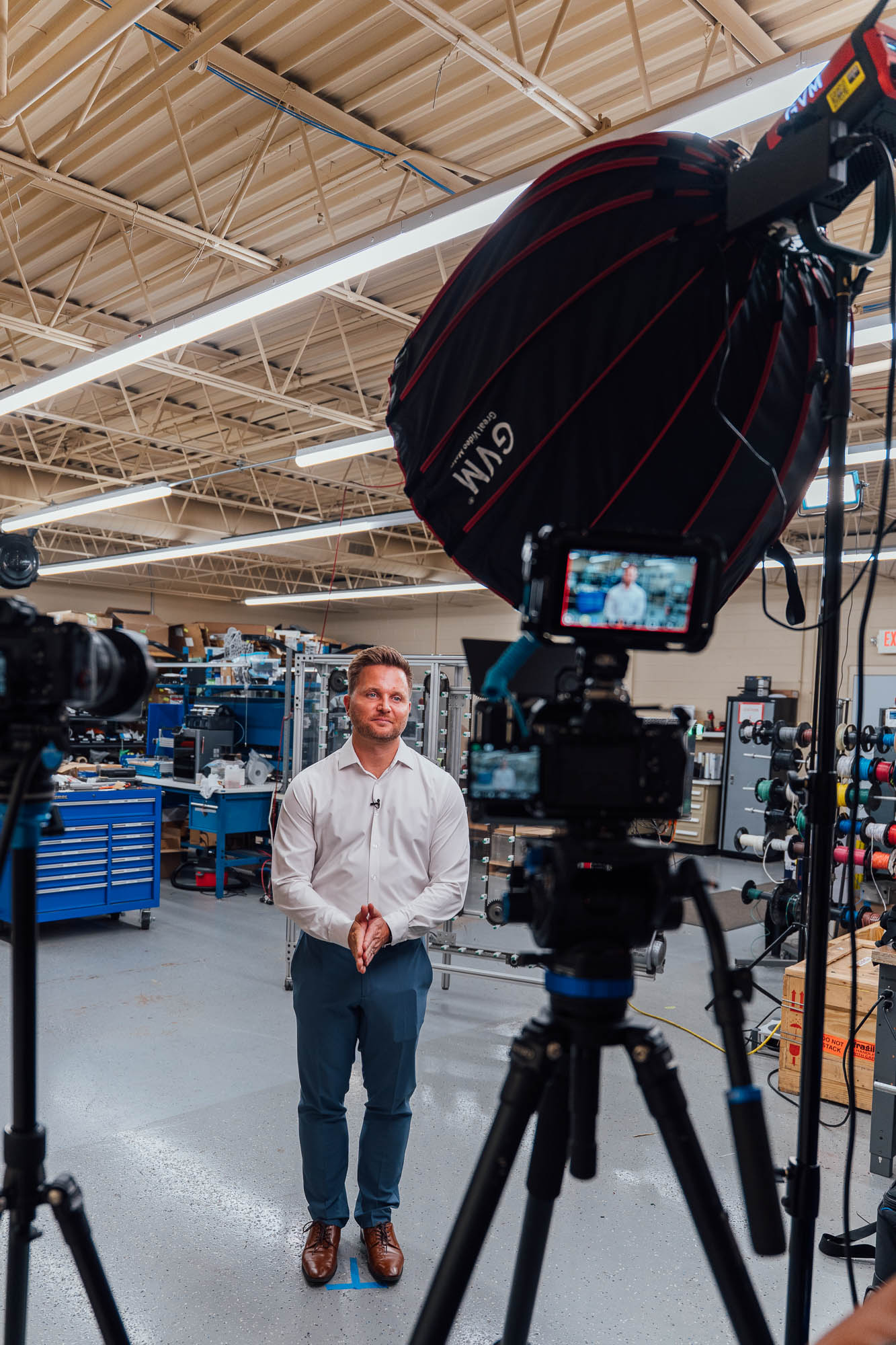 Two-camera interview setup on a manufacturing floor